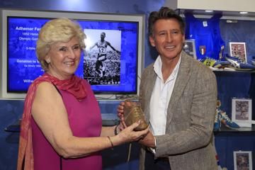 Rosemary Mula presents Seb Coe with the Melbourne 1952 Olympic winning spike of Adhemar da Silva