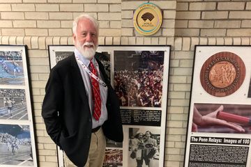 Former Penn Relays Meeting Director Dave Johnson and replica World Athletics Heritage Plaque at Franklin Field