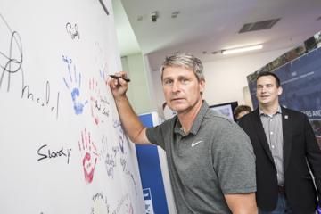Jan Zelezny adds his hand print and autograph to the visitors' wall at the IAAF Heritage Exhibition in Ostrava